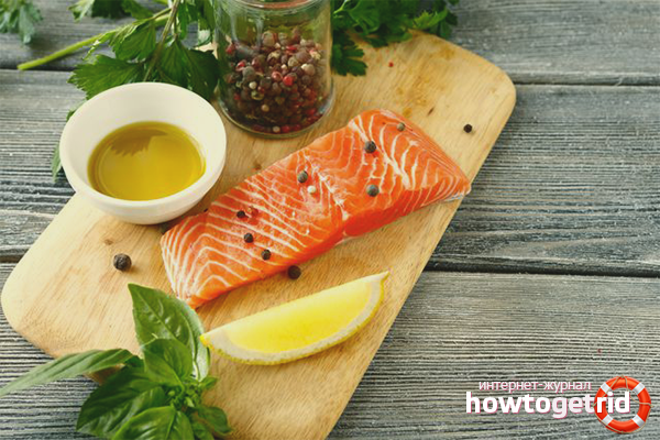 Salting coho salmon fish in olive oil